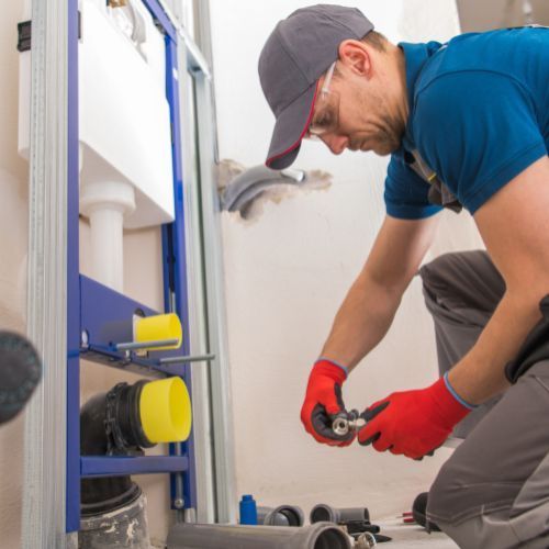 Professional plumber installing pipes in Gaston County